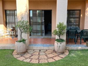two large vases with trees in them on a patio at Bult-Op1 in Bloemfontein