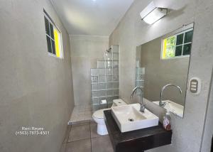 a bathroom with a sink and a toilet at Las Veraneras Villa - Pet Friendly in Acajutla +24 photos
