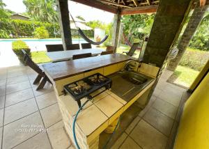 an outdoor kitchen with a stove and a sink at Las Veraneras Villa - Pet Friendly in Acajutla