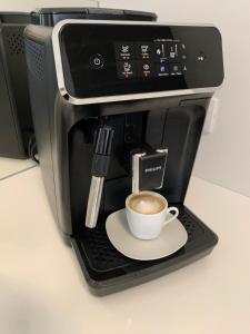 a cup of coffee sitting on top of a coffee maker at Apartment Studio Salvetti in Piran