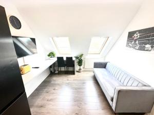 a living room with a couch and a desk at Stunning Modern, Private Apartment,15 Mins To Central London in The Hyde