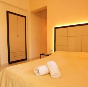 a bedroom with a bed with two towels on it at Studios Kierion #2 in Skala Potamias