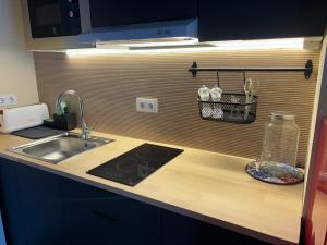 a kitchen with a sink and a counter top with a counter top at Studio 2 Port Valencia in Valencia