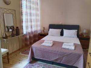a bedroom with a bed with two towels on it at 1920 Classic in Kalamata