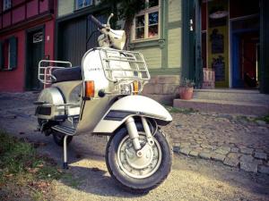 a motor scooter parked in front of a building at Holiday apartment sunshine in Quedlinburg