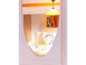 a mirror reflecting a chair in a room at Holiday apartment sunshine in Quedlinburg