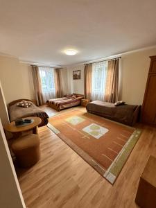 a living room with two beds and a couch at Holica in Krynica Zdrój +4 photos