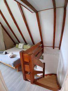 a small room with a bed and a staircase at Gite Pinot Gris et gite Pinot Blanc in Kaysersberg