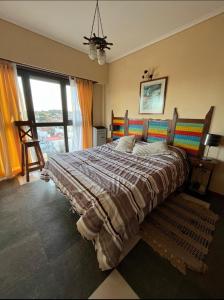 a bedroom with a large bed and a large window at Punta Mogotes,hermosa vista al mar y al atardecer in Mar del Plata