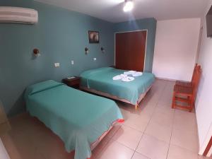 Postel nebo postele na pokoji v ubytování Apart Hotel Nonquen