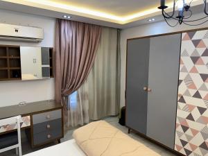 a bedroom with a bed and a dresser and a closet at شقة فندقية على النيل in Mansoura