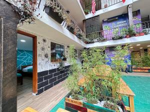 a hotel with a swimming pool and plants in the courtyard at El Jardín Escondido by Soma in Baños