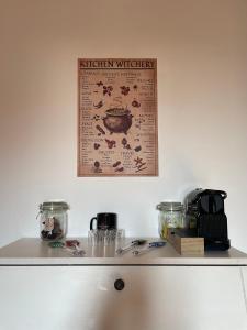 a kitchen counter with a poster on the wall at Harry Potter House - 10 min to Centrale in Milan