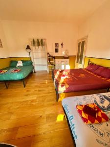 a room with three beds and a kitchen in it at Harry Potter House - 10 min to Centrale in Milan