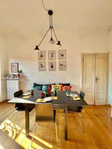 a dining room with a table and a couch at Harry Potter House - 10 min to Centrale in Milan +30 photos