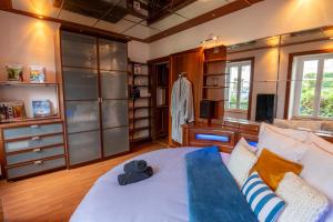 a large room with a bed and a dresser at Cocon atypique en rive droite in Brest