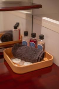 a tray with four bottles on a table at Cocon atypique en rive droite in Brest