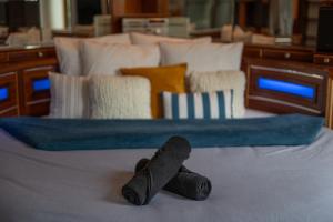 a pair of slippers sitting on top of a bed at Cocon atypique en rive droite in Brest