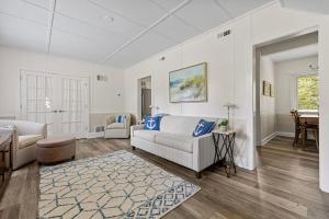 a living room with a couch and a table at Whispering Arbor in Lakeside