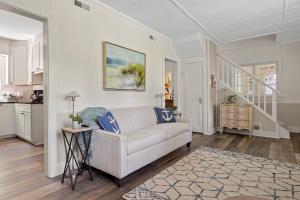 a living room with a couch and a kitchen at Whispering Arbor in Lakeside +31 photos