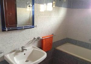 a bathroom with a sink and a bath tub at La Belle maison in Dakar