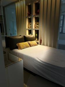 a bed with two pillows on it in a room at Overnight @ Shakhbot's in Manila