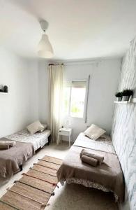 Ένα ή περισσότερα κρεβάτια σε δωμάτιο στο Apartamento V CENTENARIO BEACH Sanlúcar