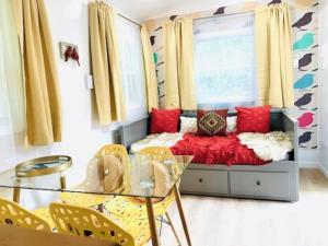 a living room with a couch and a glass table at Red Peacock Catskill Cabin sleeps four 6 in Shandaken +14 photos