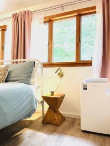 a bedroom with a bed and a window at Catskills The Bohemian Dream in Shandaken