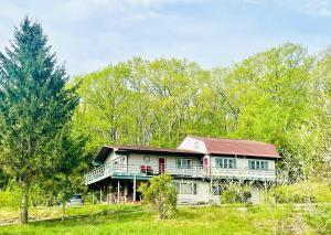 a large house in the middle of a field at Paloma Large Gathering Apartment in Shandaken