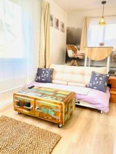 a living room with a couch and a coffee table at Catskill Cabin Little Owl Apt 1 in Shandaken