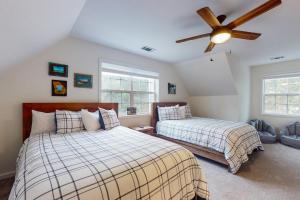 a bedroom with two beds and a ceiling fan at Lake Nottely Getaway in Mashburn Mill