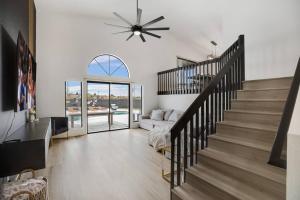 a living room with a staircase and a couch at Lux Fun Zone Home - Sleeps 16 in Mesa