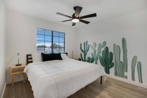 a bedroom with a bed and a ceiling fan at Lux Fun Zone Home - Sleeps 16 in Mesa +50 photos