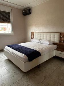 a bedroom with a large white bed in a room at Maison Wartas in Berkane +19 photos