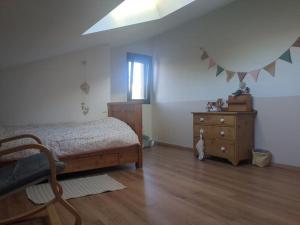 a bedroom with a bed and a dresser and a window at maison familiale gap PROMO in Gap