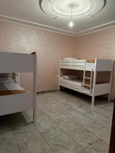 a room with two bunk beds and a ceiling at Maison Wartas in Berkawe +19 photos