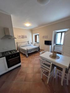 a kitchen and living room with a bed and a table at Residenze Ponte in Ponte