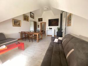 un soggiorno con un divano e un tavolo di Le Grimaubois a Hurbache