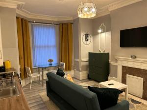 a living room with a couch and a fireplace at Flat 1 in Nottingham
