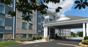a building with a parking garage in front of it at Comfort Inn & Suites Glen Mills - West Chester in Glen Mills