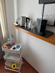 a shelf with a coffee maker and a toaster at Nature House Almograve - Double Room with terrace and private bathroom - Fishermen's Trail in Almograve