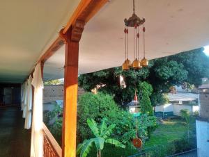 a porch with a view of a garden at Casa Verde in Quillabamba