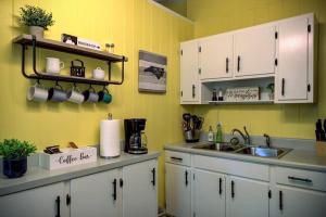 a kitchen with white cabinets and a sink at Mountain Home near Blue Ridge Parkway, Central Location! in Blowing Rock