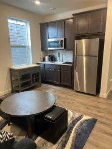 a kitchen with a table and a stainless steel refrigerator at A cozy house in Parker, Colorado in Parker