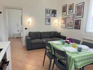 een woonkamer met een tafel en een bank bij 10' Malpensa Airport, alongside Train Station in Casorate Sempione +11 foto's