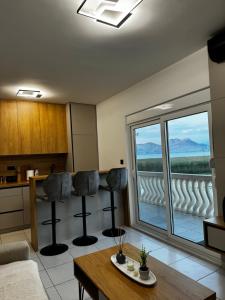 a living room with a table and a large window at Lakeside house in Podgorica +14 photos