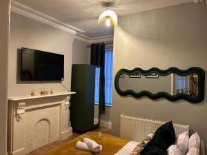 a living room with a fireplace and a flat screen tv at Flat 1 in Nottingham