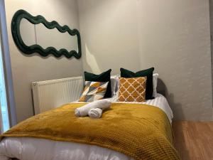 a bedroom with a bed with a mirror on the wall at Flat 1 in Nottingham +1 photo