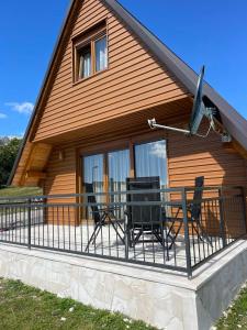 a house with a balcony with chairs on it at Snowflake in Žabljak
